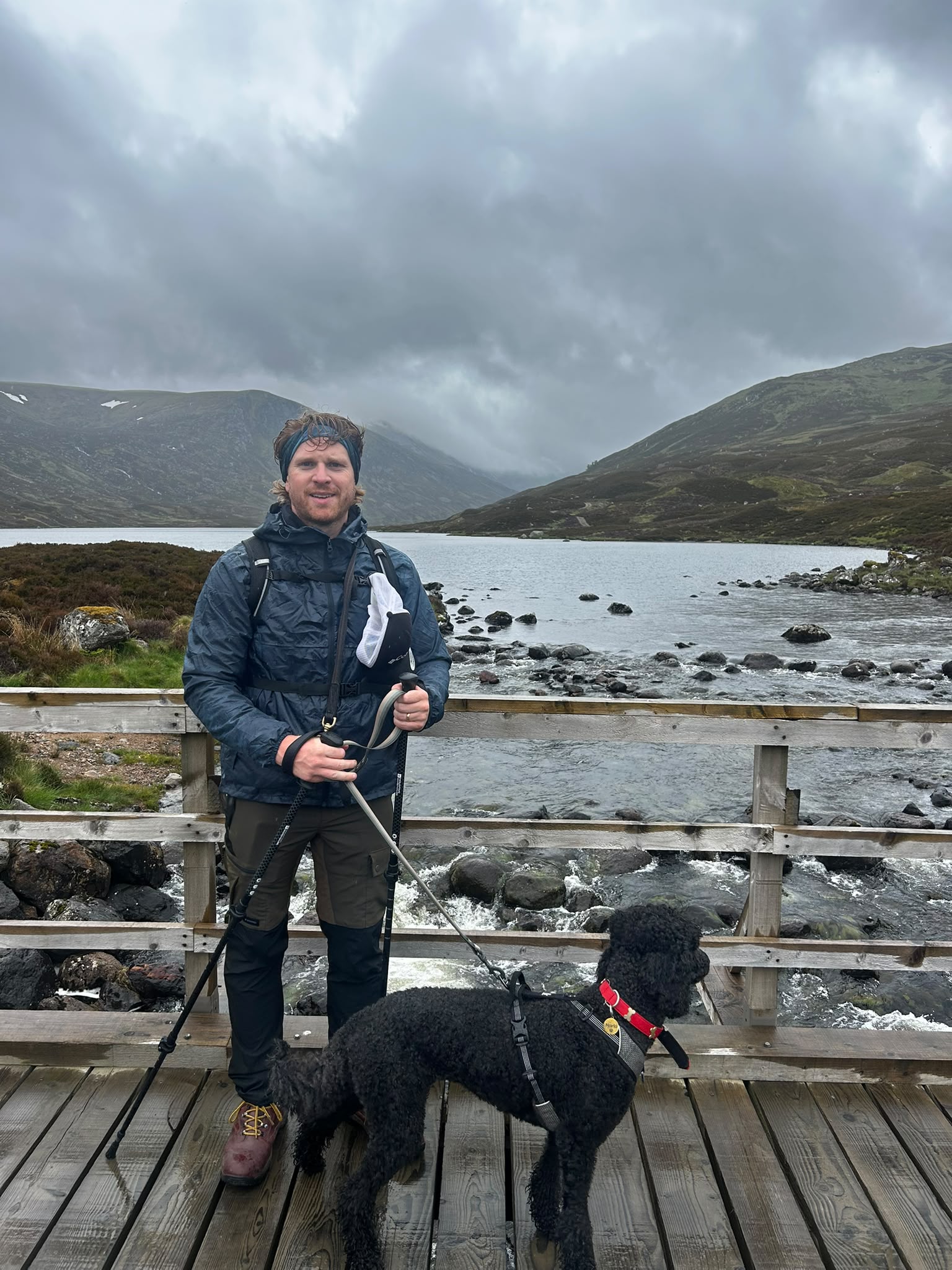 Scott Angus hiking in the Scottish Highlands with his dog